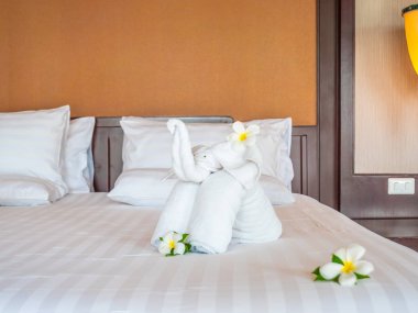 Beyaz fil havlu ve yatak otel yatak odası iç dekorasyonda rahat yastık