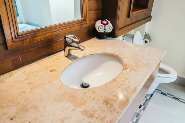White sink and water facuet decoration in barhroom interior
