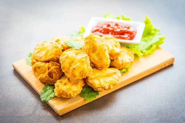 Derin kızarmış tavuk eti çağrı nugget ahşap plaka - fast food ve önemsiz üzerinde domates veya ketçap sos ile