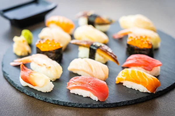 Nigiri suşi somon balıklı karides karides yılan balığı deniz hayvanı kabuğu ve diğer sashimi ile siyah kayrak - Japansese gıda stilini ayarla