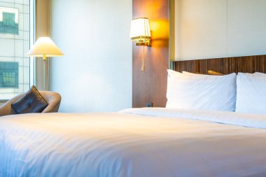 Güzel rahat beyaz yastık yatak yatak odası iç dekorasyonda ışık lamba ile