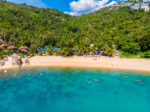 Aerial view of beautiful tropical beach and sea with palm and other tree in koh samui island for travel and vacation