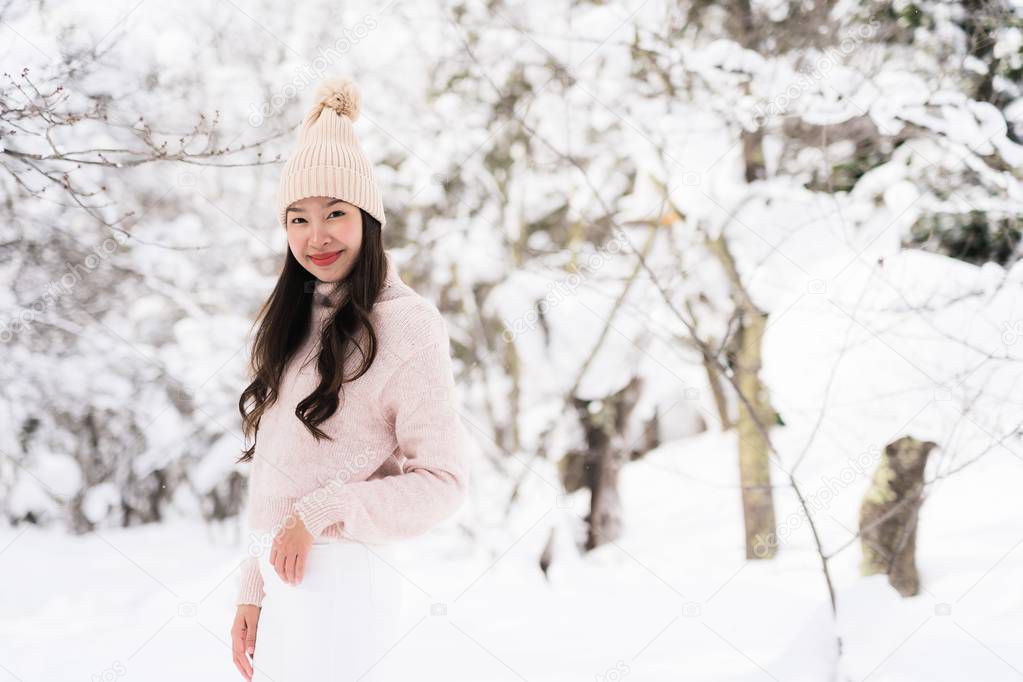 Portrait Young Beautiful asian woman smile happy travel and enjoy with snow winter season in Hokkaido Sapporo Japan