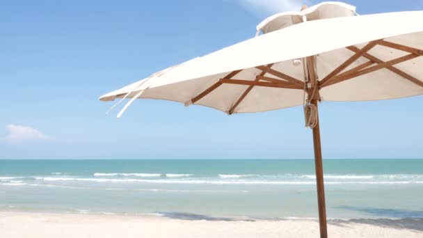 宁静的镜头美丽的波浪形大海与阳光伞在海滩上 — 图库视频影像
