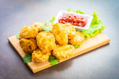 Derin kızarmış tavuk eti çağrı nugget ahşap plaka - fast food ve önemsiz üzerinde domates veya ketçap sos ile