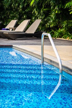 Yatak şezlong ve şemsiye tatil için seyahat ve tatil kavramı ile güzel Açık Yüzme Havuzu
