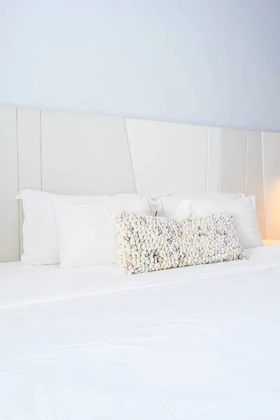 White pillow and blanket on bed decoration in beautiful luxury bedroom interior