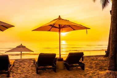 Şemsiye ve güzel plaj ve deniz gündoğumu, sandalyeye tim