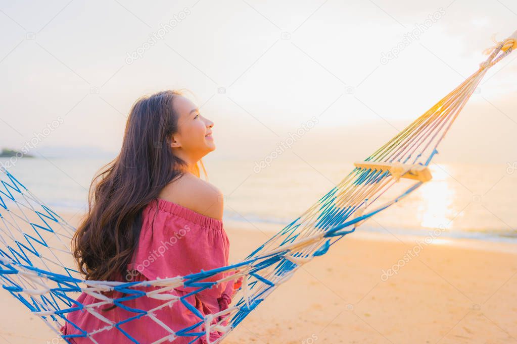 Portrait beautiful young asian woman sitting on the hammock with