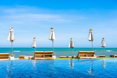 Güzel açık doğa manzara ile yatak şezlong otel tatil için seyahat ve tatil kavramı mavi gökyüzü arka plan üzerinde Yüzme Havuzu etrafında