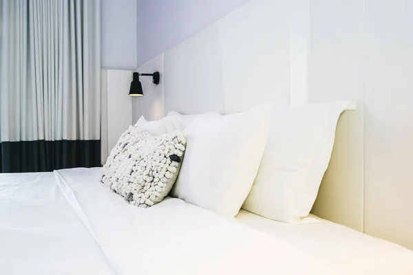 White pillow and blanket on bed decoration in beautiful luxury bedroom interior