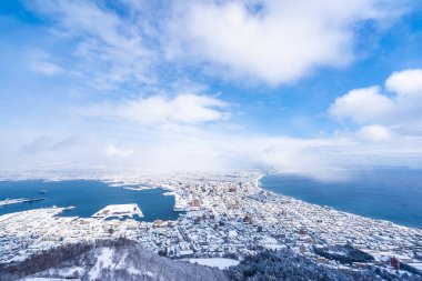 Güzel manzara ve şehir manzarası kurma ve mavi gökyüzü beyaz bulut mimarisiyle etrafa bakmak için gelen dağ Hakodate cityscape