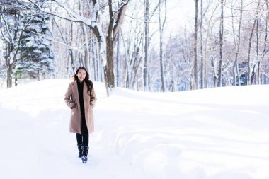Portre genç güzel Asyalı kadın mutlu seyahat gülümseme ve kar kış sezonu Hokkaido Sapporo Japonya'da zevk.