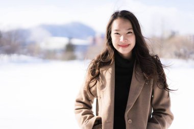 Portre genç güzel Asyalı kadın mutlu seyahat gülümseme ve kar kış sezonu Hokkaido Sapporo Japonya'da zevk.