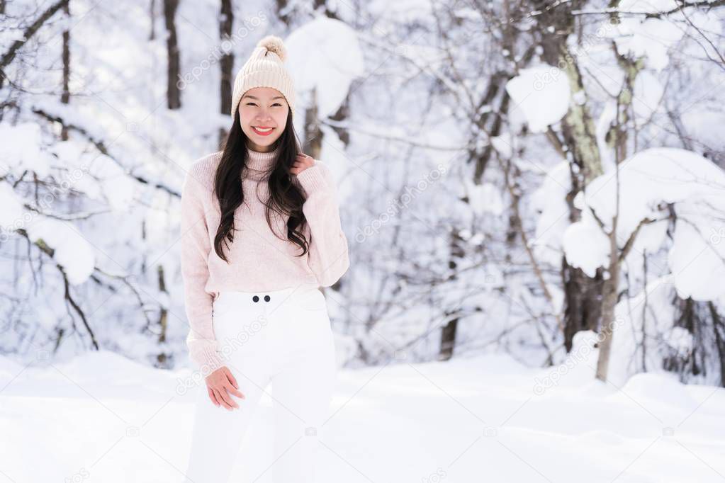 Portrait Young Beautiful asian woman smile happy travel and enjoy with snow winter season in Hokkaido Sapporo Japan