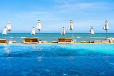 Güzel açık doğa manzara ile yatak şezlong otel tatil için seyahat ve tatil kavramı mavi gökyüzü arka plan üzerinde Yüzme Havuzu etrafında