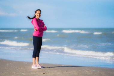Portre güzel genç asya kadın çalışan veya sağlıklı bir kavram için plaj deniz okyanusunun tropica doğa manzara egzersiz