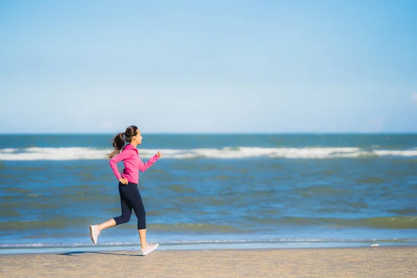 stock image Portrait beautiful young asian woman running or exercise on the tropica nature landscape of beach sea ocean for healthy concept