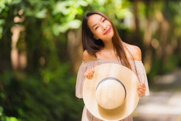 Portrait beautiful young asian woman smile happy and feel free with outdoor background for freedom concept