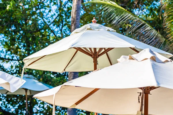 Beautiful outdoor tropical nature with white umbrella around bea — Stock Photo, Image