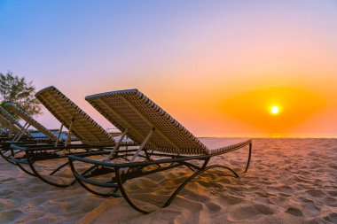 Boş seyahat ve tatil için gün doğumu veya günbatımı saatinde tropikal doğa plaj ve okyanus denizinde Boş sandalye