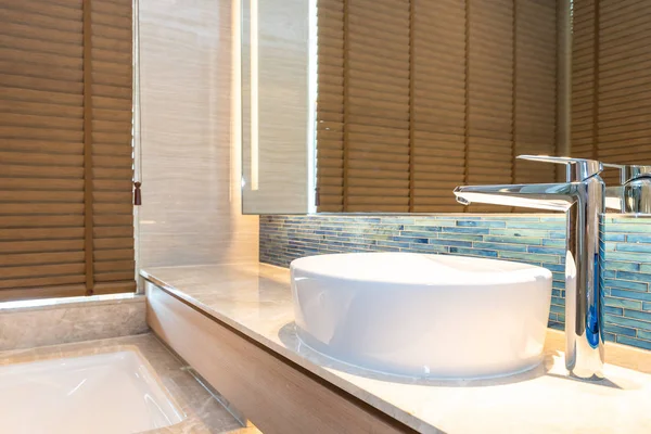 Water faucet and white sink decoration in bathroom interior