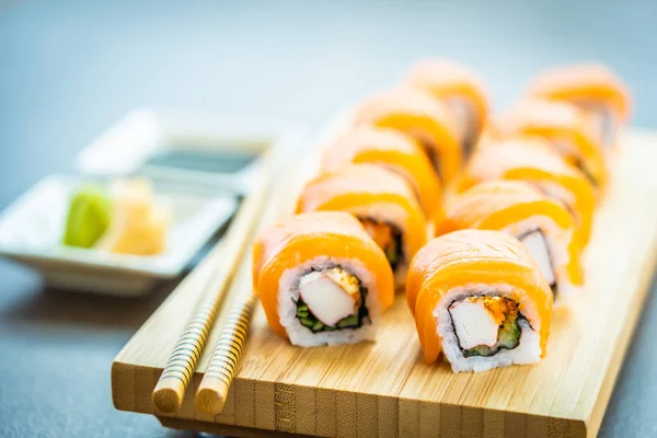 Rybne mięso sushi roll maki na drewno płyta z łososia — Zdjęcie stockowe