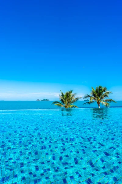 Beautiful luxury outdoor swimming pool in hotel resort with sea — Stock Photo, Image