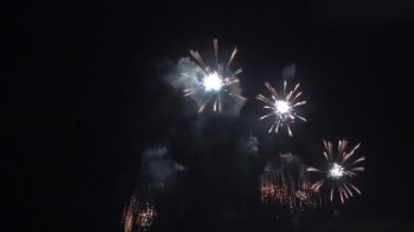 Gece gökyüzünde patlayan havai fişeklerin yakın çekim görüntüleri.