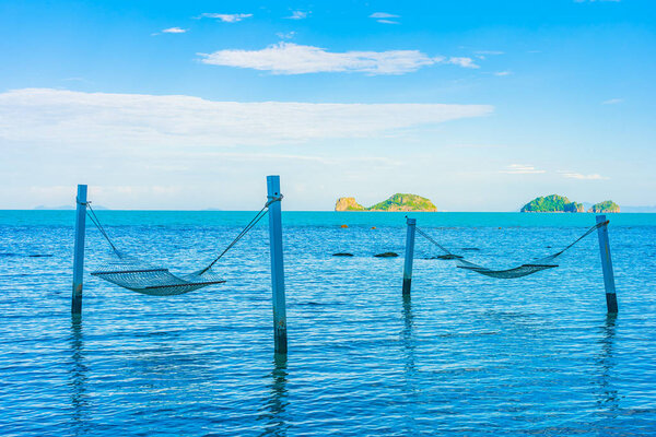 Empty hammock around beautiful beach sea ocean for relax in holi