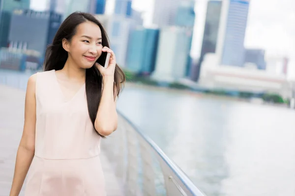 Asian woman using smartphone or mobile phone for talking or text — Stock Photo, Image