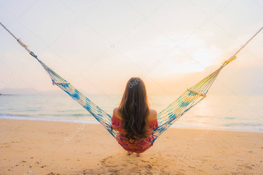 Portrait beautiful young asian woman sitting on the hammock with