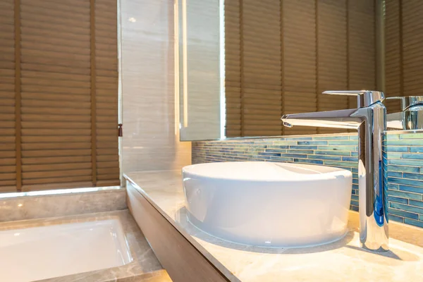 Water faucet and white sink decoration in bathroom interior