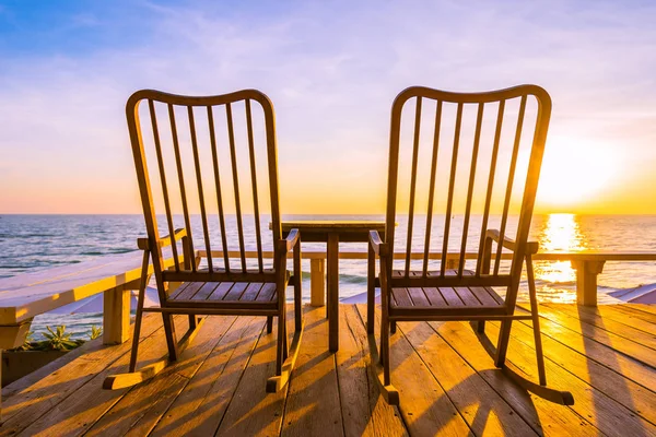 Empty wood chair and table at outdoor patio with beautiful tropi — Stock Photo, Image