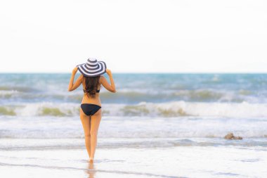 Portre güzel genç Asyalı kadın plaj se üzerinde bikini giymek