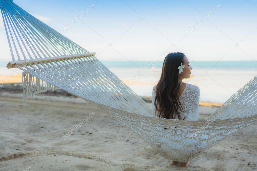 Portrait beautiful young asian woman sitting on hammock around s