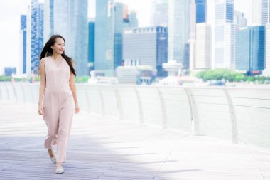 Asyalı kadın konuşmak veya metin için akıllı telefon veya cep telefonu kullanarak