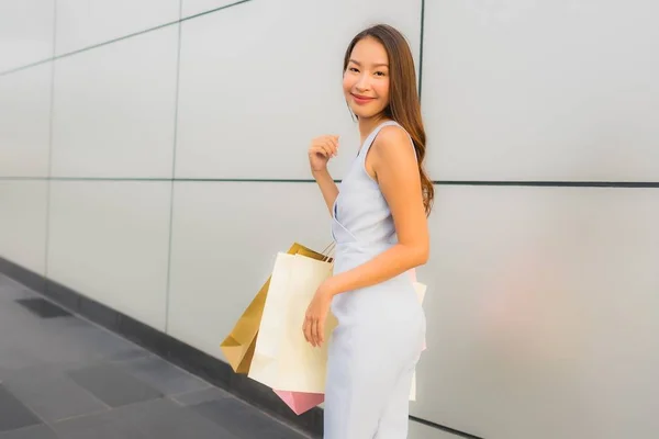 Porträtt vacker ung asiatisk kvinna lycklig och leende med shoppingga — Stockfoto