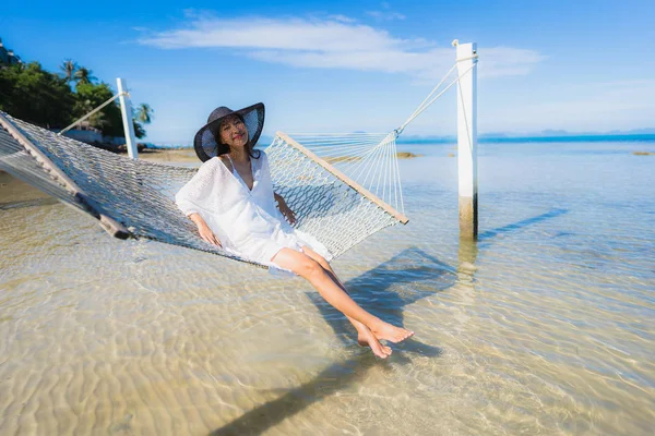 Portre güzel genç Asyalı kadın etrafında hamak üzerinde oturuyor s