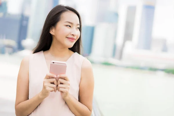 Asian woman using smartphone or mobile phone for talking or text — Stock Photo, Image