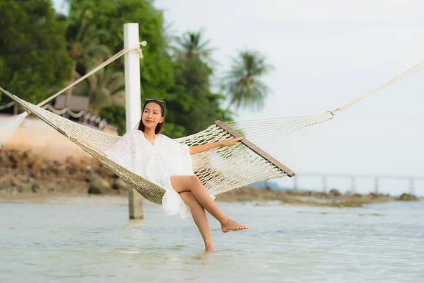 Portrait beautiful young asian woman sitting on hammock around s — Stock Photo, Image