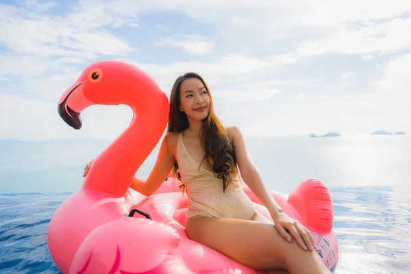 Portrait jeune femme asiatique sur flotteur gonflable flamant rose autour de o — Photo