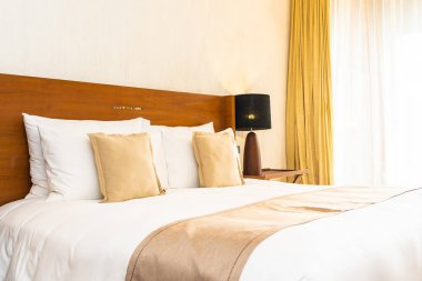 Yatak üzerinde güzel konforlu lüks beyaz yastık ve battaniye Dec