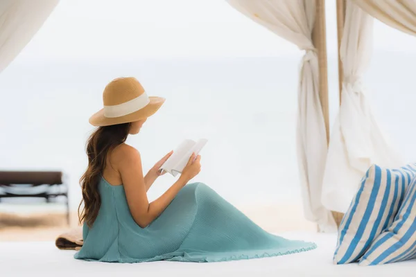 Портрет молодой женщины, читающей книгу на пляже — стоковое фото