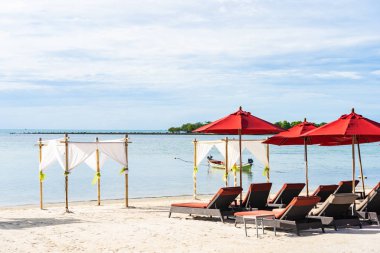 Şemsiye sandalye ile güzel açık tropikal plaj deniz Okyanusu