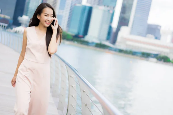 Asian woman using smartphone or mobile phone for talking or text — Stock Photo, Image