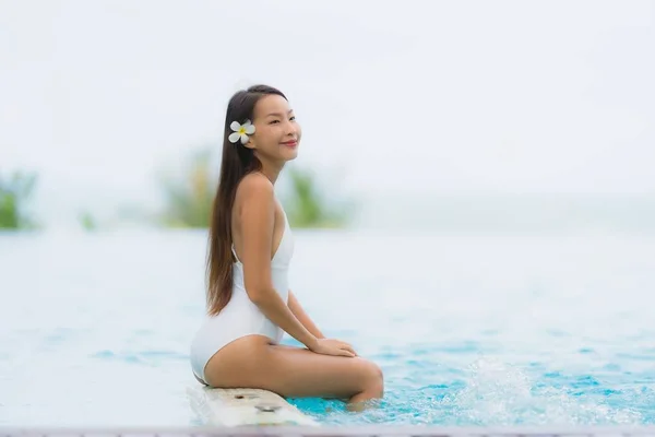 Portrait young asian woman happy smile relax around swimming poo