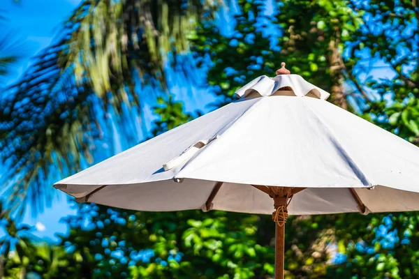 Beautiful outdoor tropical nature with white umbrella around bea