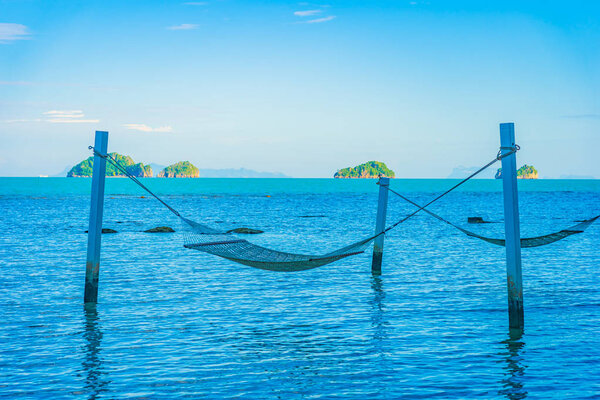 Empty hammock around beautiful beach sea ocean for relax in holi