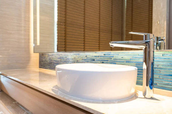 Water faucet and white sink decoration in bathroom interior